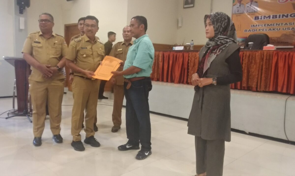 Penyerahan secara simbolis perizinan berusaha kepada pelaku usaha peternakan di Hotel Pesona Alam Sangir, Solok Selatan, Selasa (6/6). KIKI NOFRIJUM