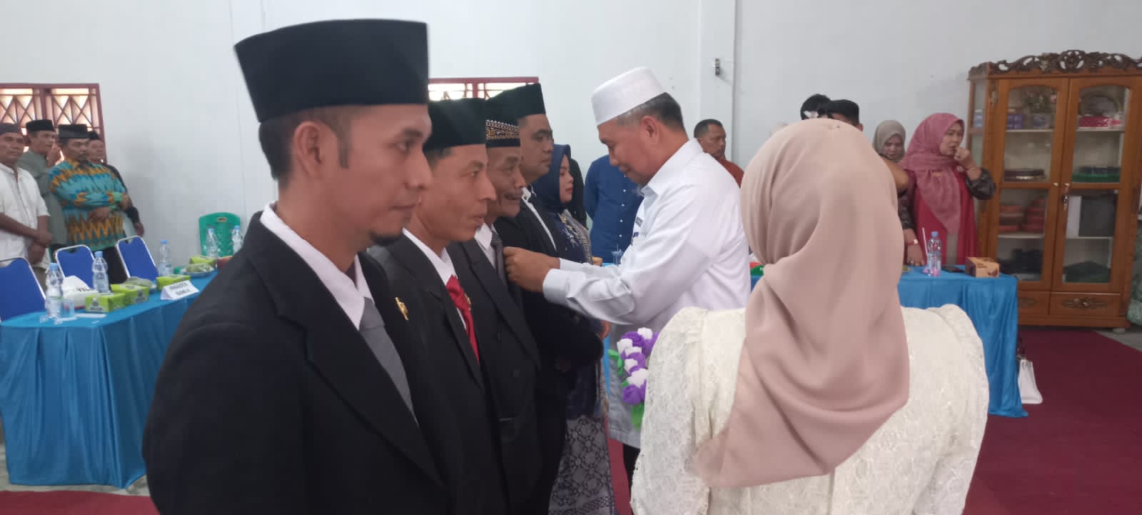 Bupati Hamsuardi memasang tanda jabatan kepada Bamus yang dilantik. Osniwati