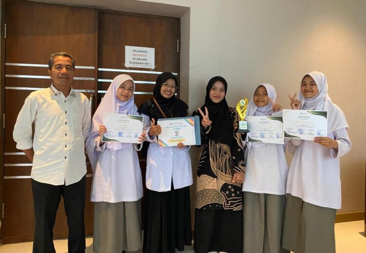 Siswi MAN 2 Bukittinggi meraih Juara 3 dalam lomba daur ulang dengan karya gaun unik yang dirancang dari botol air mineral. IST