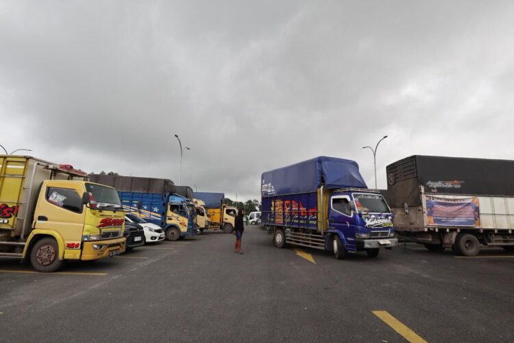 Sejumlah truk yang membawa barang bantuan warga terdampak bencana hidrometeorologi Aceh, Sumatra Barat dan Sumatra Utara dari pemerintah dan masyarakat Provinsi Sumatra Selatan, menunggu bongkar barang di Pos Pendukung Logistik Nasional, kompleks Bandara Internasional Sisingamangaraja XII, Silangit, Sumatra Utara, Minggu (7/12).
